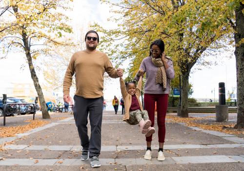 Parents and child walking in Downtown Halifax during fall