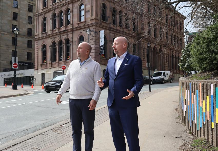 Two men talking to each other on the street 