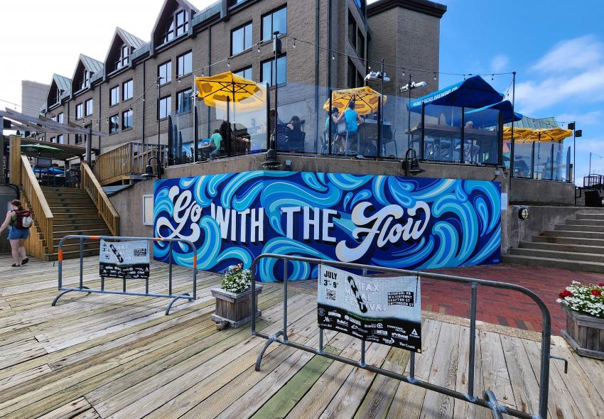Kristen De Palma mural on a Halifax Marriott Harbourfront wall that says "Go With The Flow"