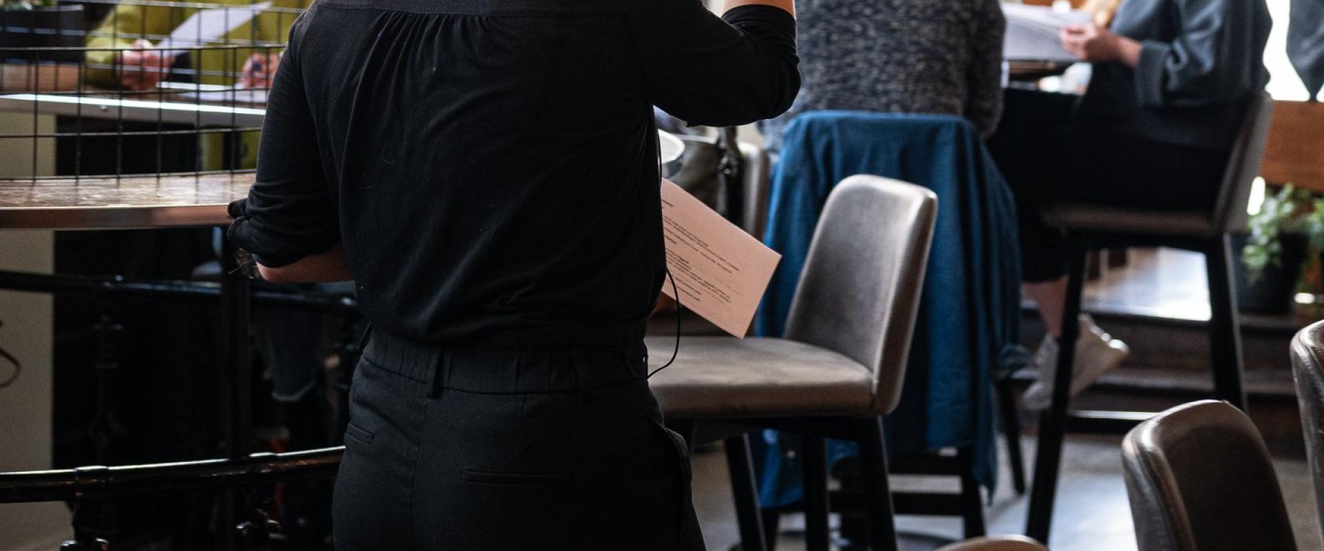 Heather rankin wearing a microphone, teaching a class in the restaurant.