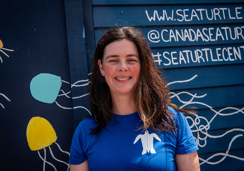 Kathleen Martin, executive director of Canadian Sea Turtle Network smiling in front of their Waterfront building.