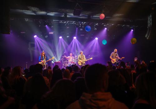 band on stage with purple lights