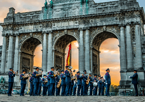 The Royal Band of the Belgian Air Force perform in front of a three arched monument in Parc du Cinquantenaire in Brussels, Belgium.