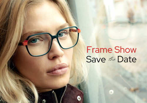 Woman leaning close to a window, wearing glasses and looking at the camera. Text: Frame Show - Save the Date