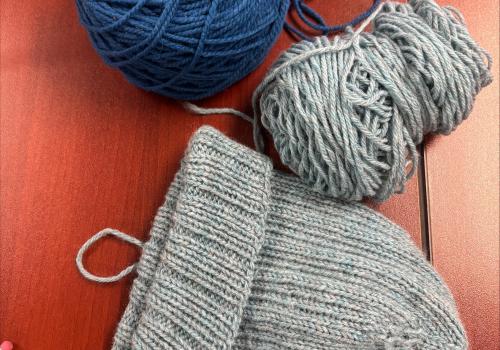 Knitted toque and yarn, promoting Knots and Knits at the Maritime Museum of the Atlantic, Tuesdays, 1 pm - 3 pm. Free drop in sessions!