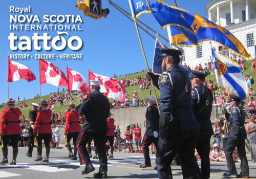 Royal Nova Scotia International Tattoo logo. RCMP members in red serge hold Canadian flags and Halifax Regional Police members in uniform hold flags while marching in a parade past the Town Clock on Citadel Hill. Crowds on the hill watch the parade go by on a sunny day.