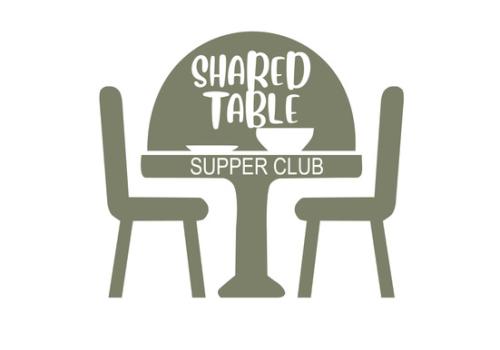 The Shared Table Logo: a cartoon of a green cafe table and two chairs with white lettering and dishes on the table.