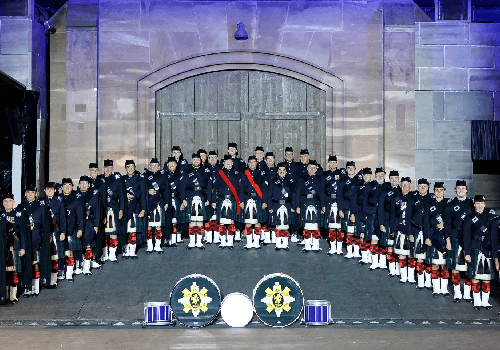 Group photo of the Scots College Old Boys Pipes and Drums dressed in ceremonial dress and kilts.