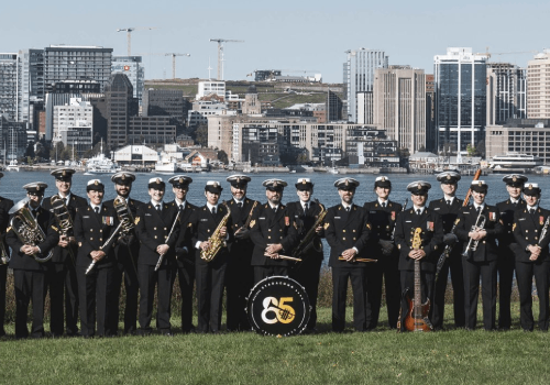 Members of the Stadacona Band pose for a unit photo with the Halifax Waterfront in the distance, taken in Dartmouth, NS, on 16 September 2025.Photo Credit: Corporal Gregory Cole, Canadian Armed Forces Photo