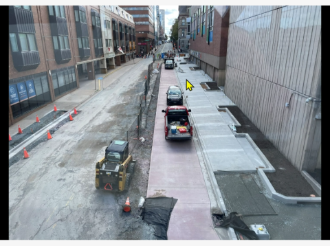 sidewalk with construction vehicles